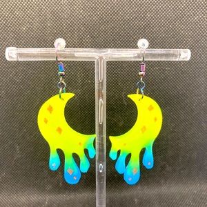 Vibrant moon shaped glow in the dark earrings.